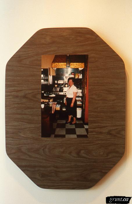 1996 06 04 The Mattering Map Project Pia Massie 11 detail woman standing in diner mounted dark wood grain counter top